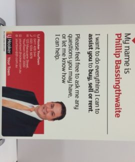 Real estate agent promotional sign with contact details