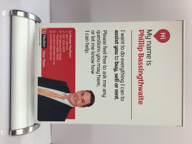 Real estate agent promotional sign with contact details