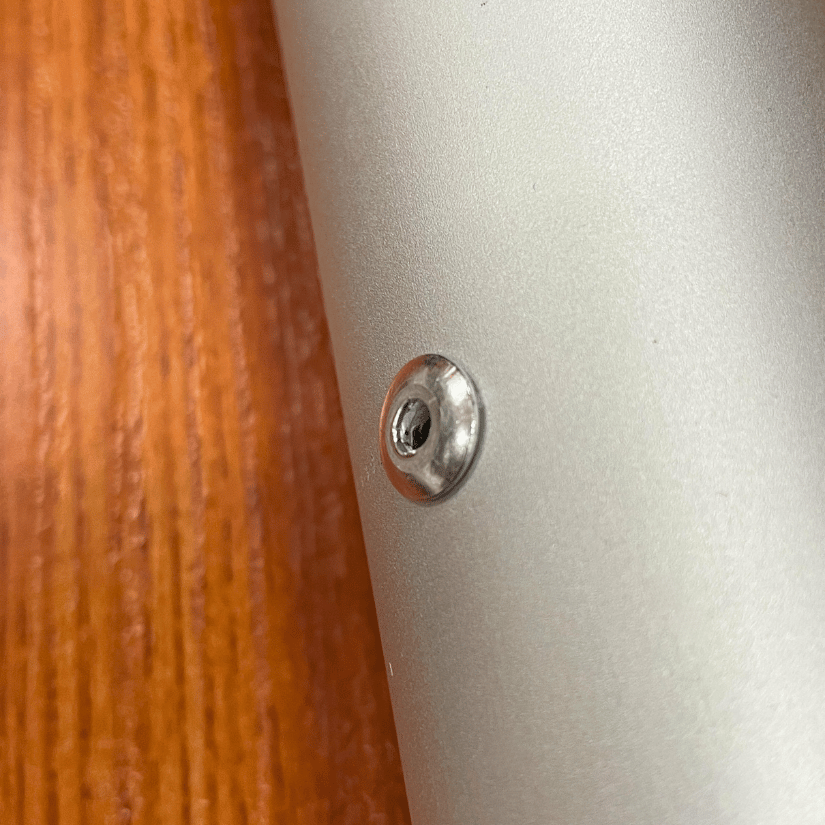 Close-up of a screw in metal surface