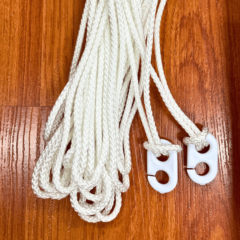 White braided cords with plastic clips on wood