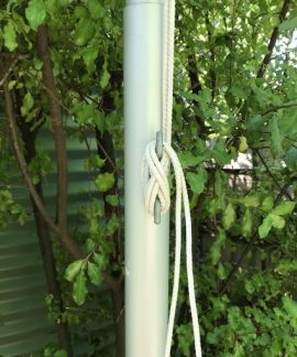 Flagpole rope secured with cleat in garden