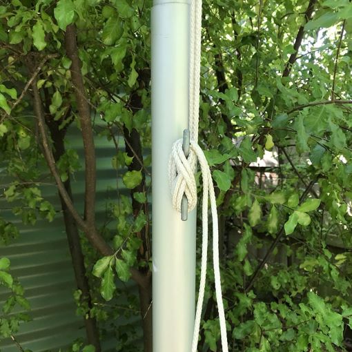 Flagpole rope secured with cleat in garden