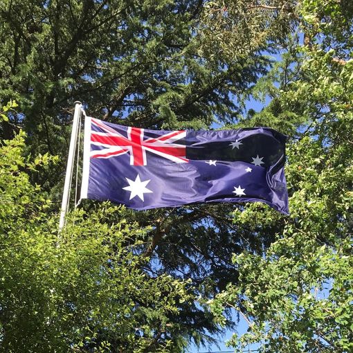 Australian flag waving among green trees