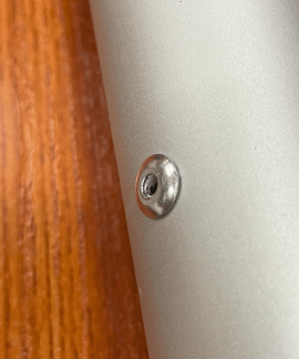 Close-up of screw in metallic surface