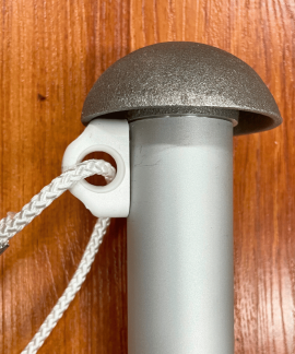 Flagpole rope and cleat on wooden background
