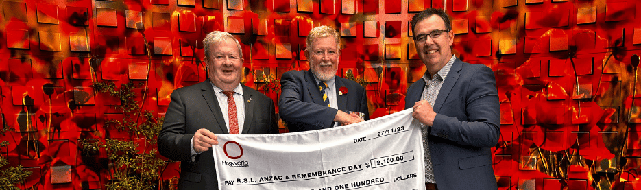 Men holding donation check for Remembrance Day event