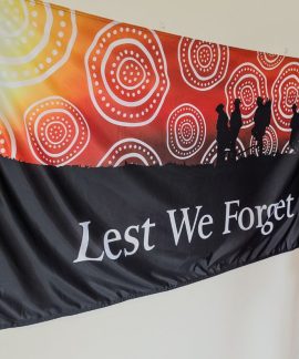Lest We Forget memorial flag with soldier silhouettes