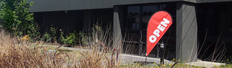 Building entrance with red open sign