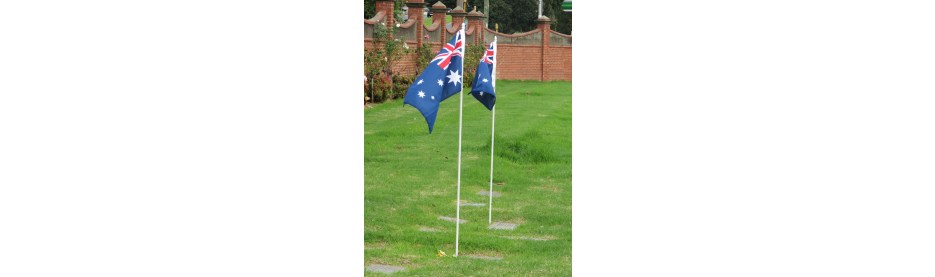 Australian flags displayed on green lawn