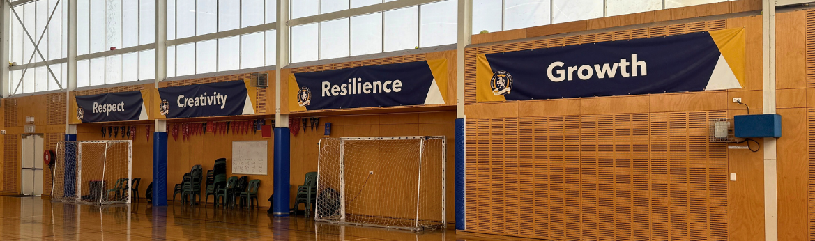 Gym wall banners showing respect, creativity, resilience, growth