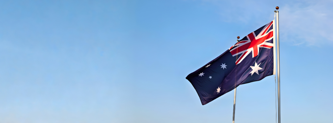 Australian flag waving against blue sky