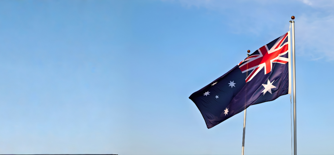 Australian flag waving against blue sky
